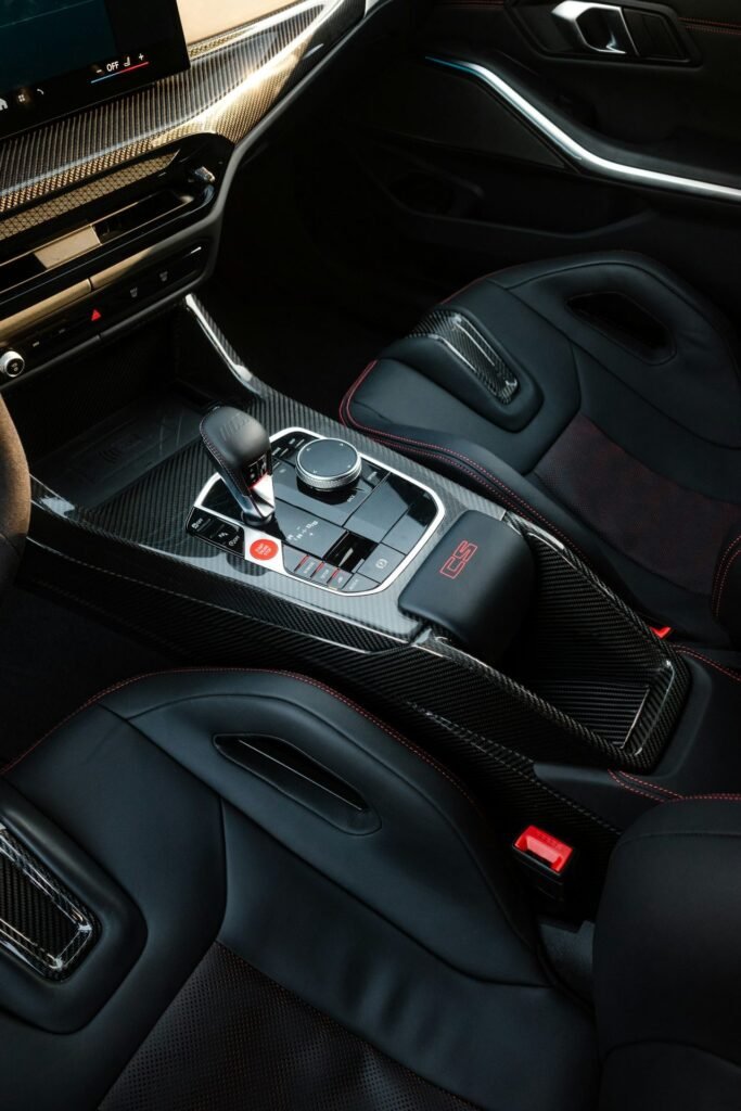 Close-up of a modern car interior with leather seats, the gear selector and the centre console